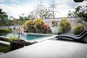 a pool with a lounge chair next to it