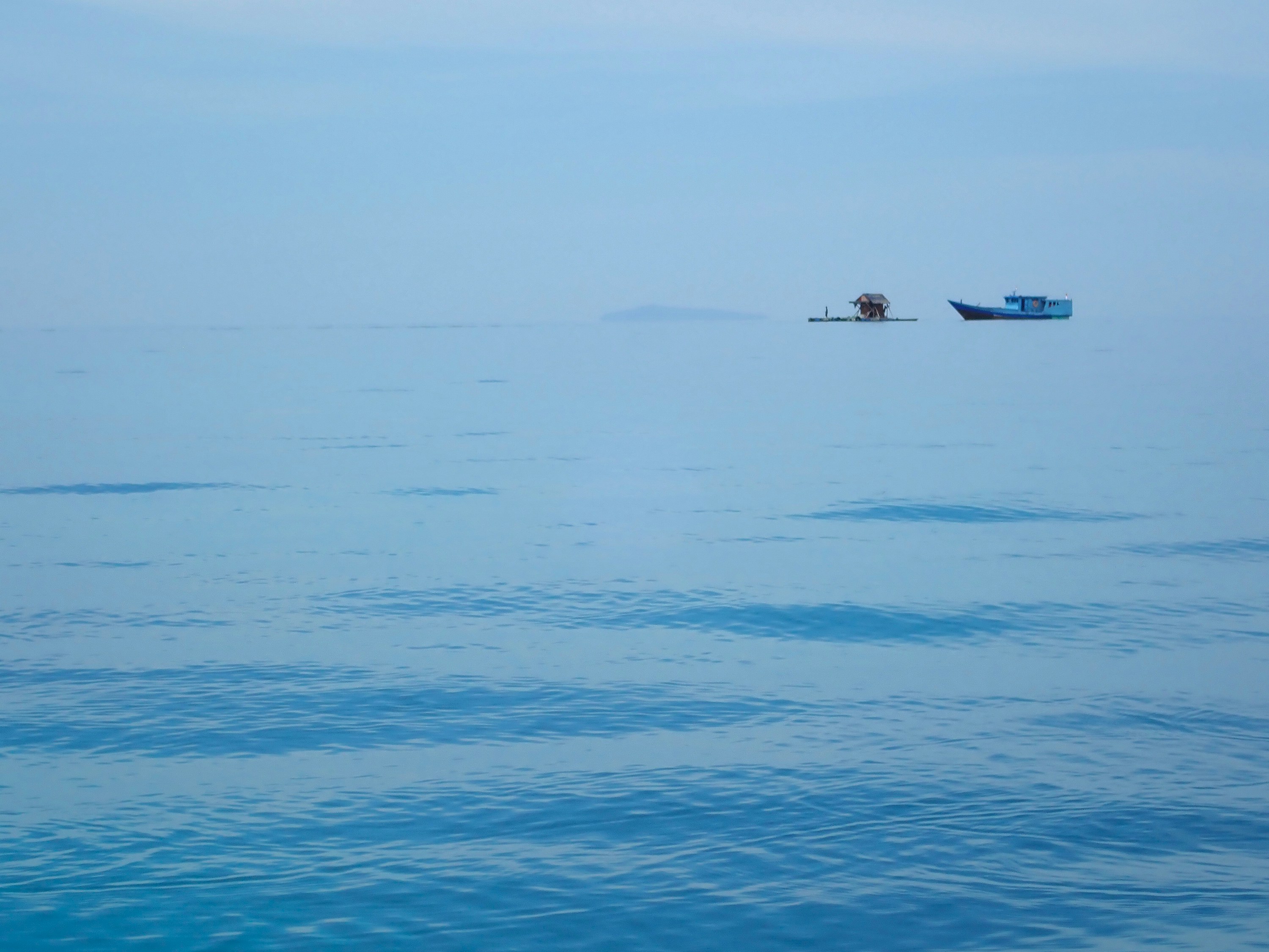a boat floating on top of a large body of water