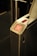 A metal turnstile gate with a red X indicator light signaling a halt or restriction, and an arrow pointing forward indicating direction. The overall design is sleek with brushed stainless steel surfaces.