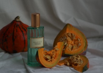 Close-up of a bottle of freshly pressed Styrian pumpkin seed oil with pumpkin seeds around it.