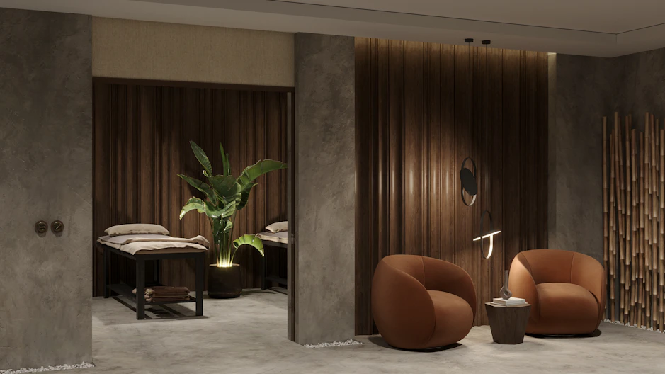 A warm, inviting photo of the Renew Massage Spa team smiling together in the cozy treatment room.