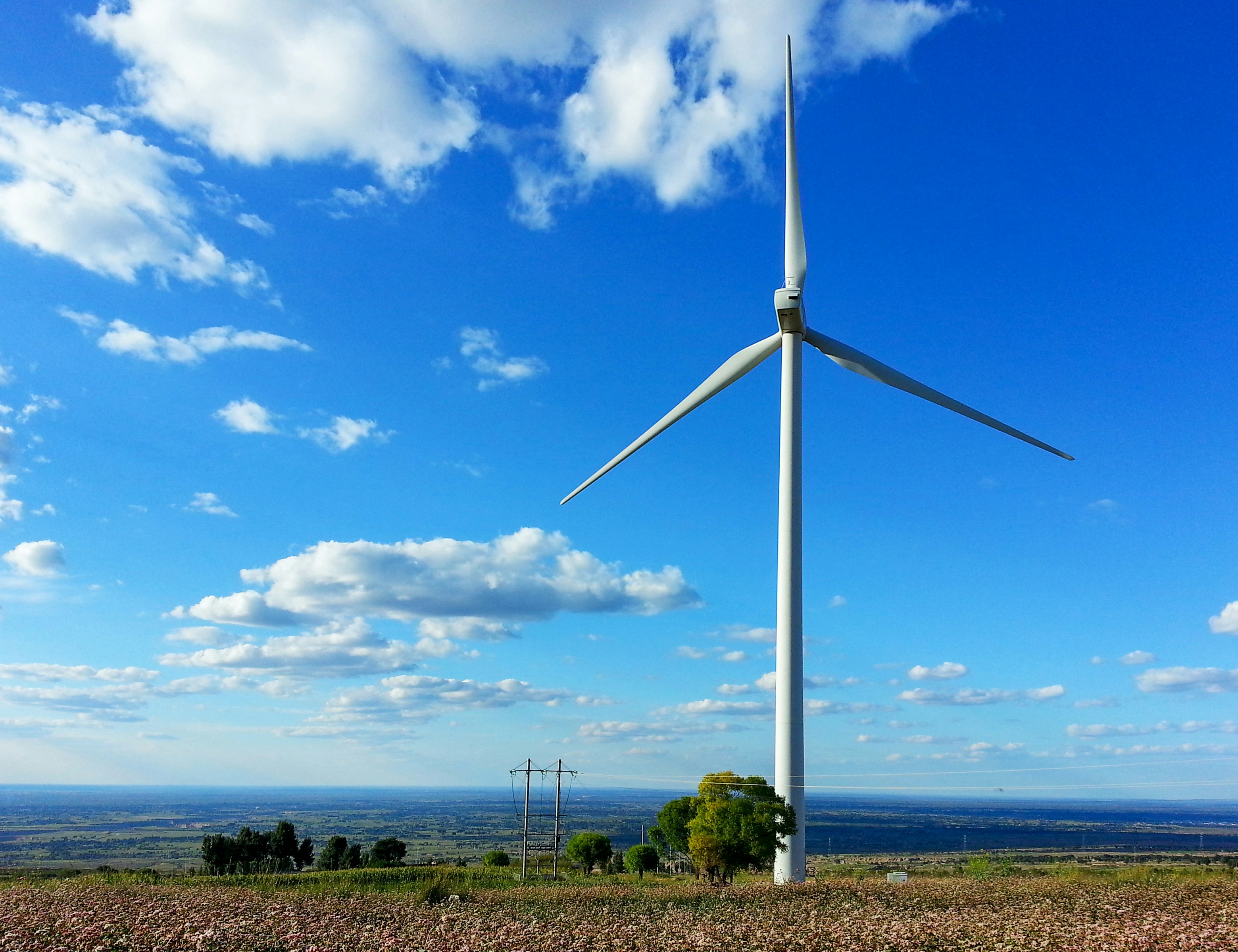 a wind turbine on top of a hill