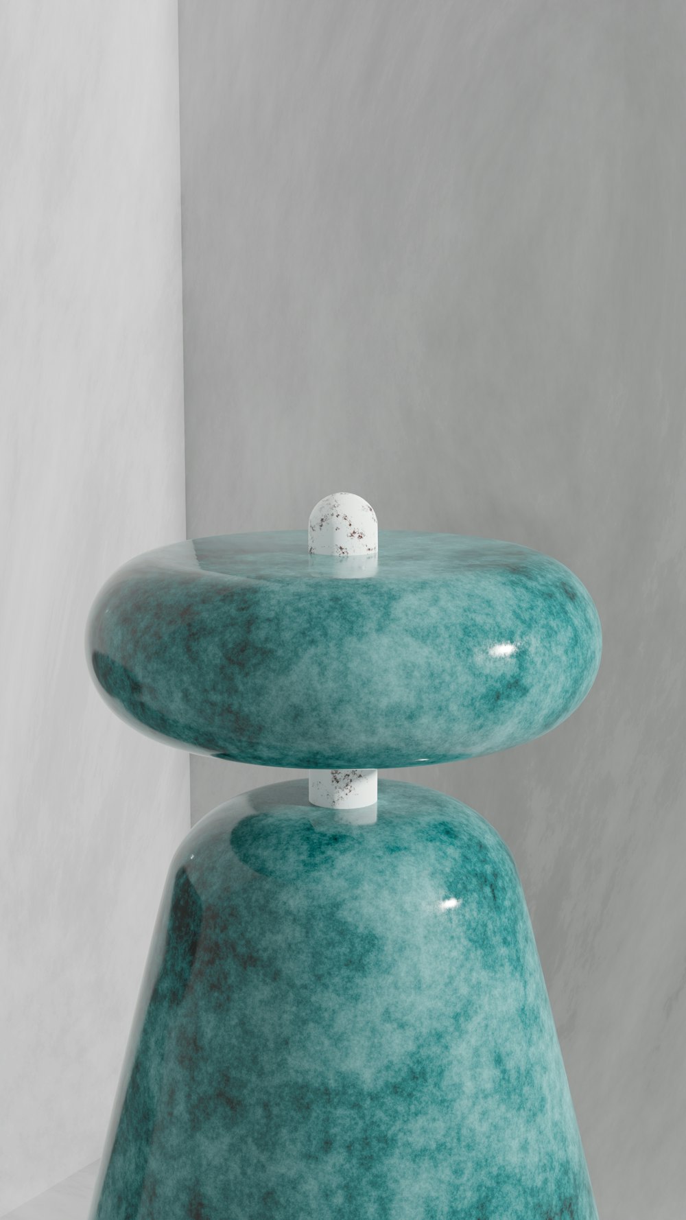 a blue vase with a white ball on top of it