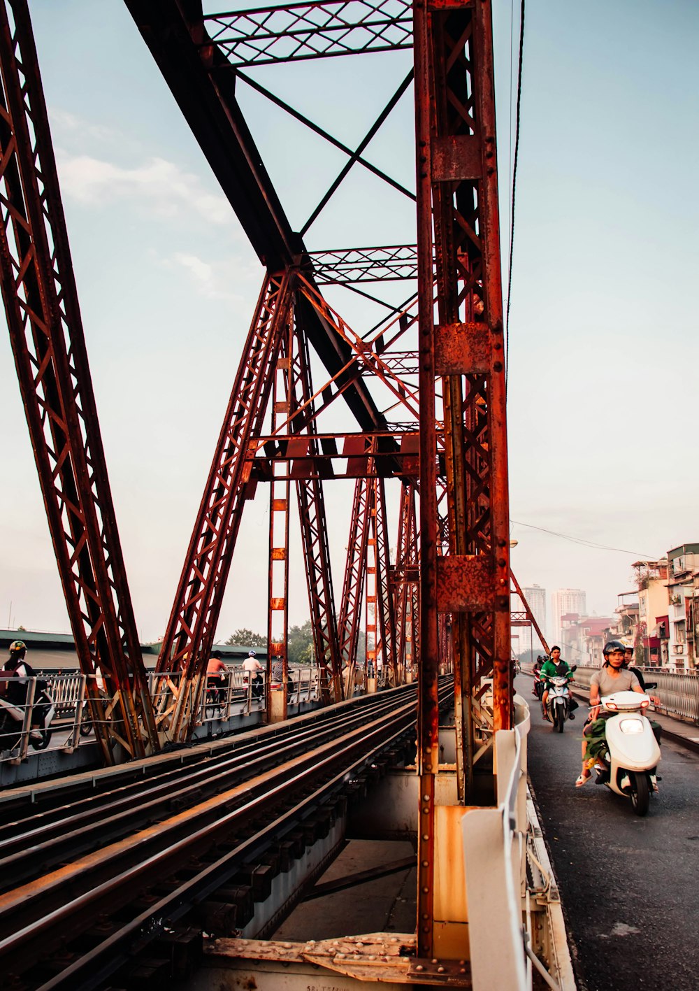 a person riding a scooter on a bridge