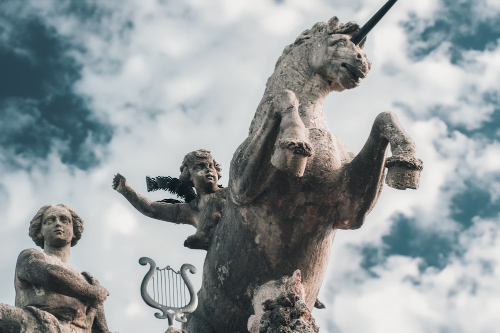 a statue of a horse and a woman holding a tennis racquet