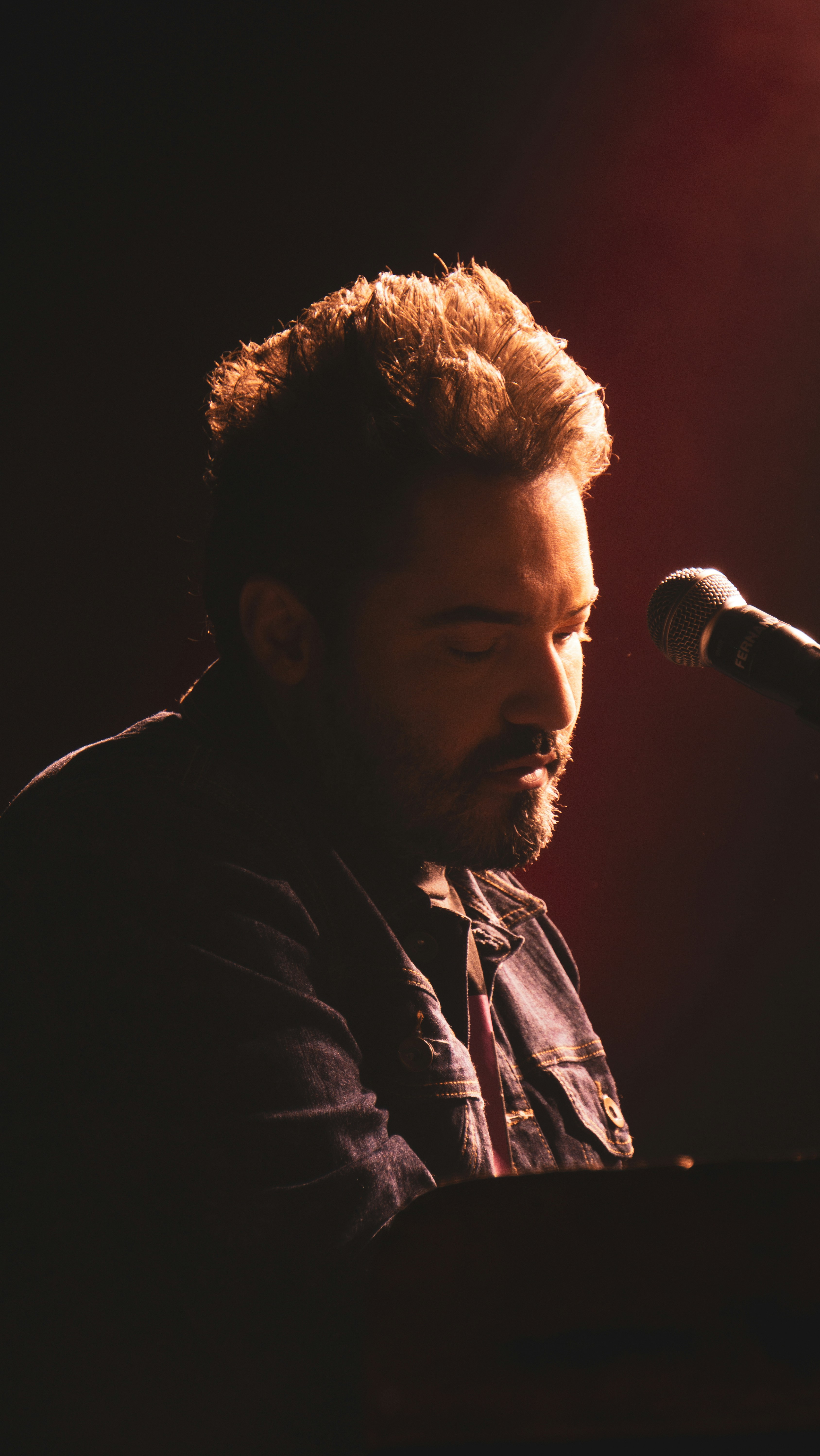 a man with a beard playing a keyboard