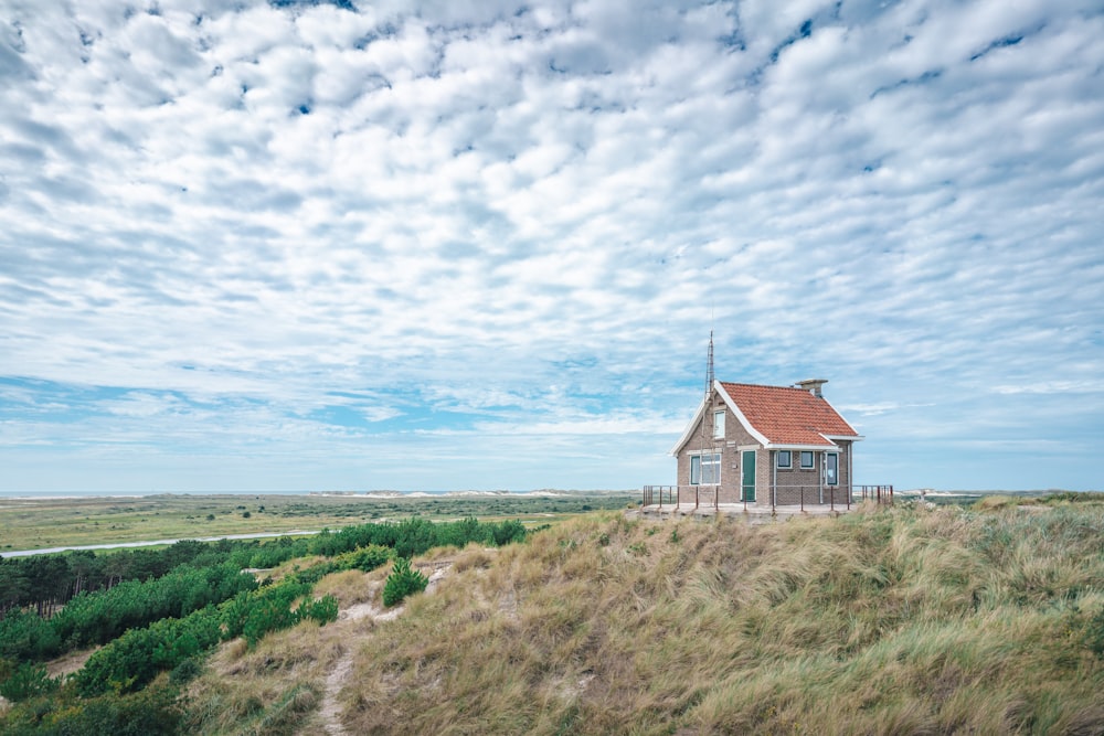 a small house sitting on top of a hill