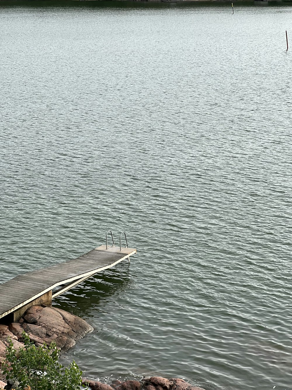 a long dock sitting on top of a body of water
