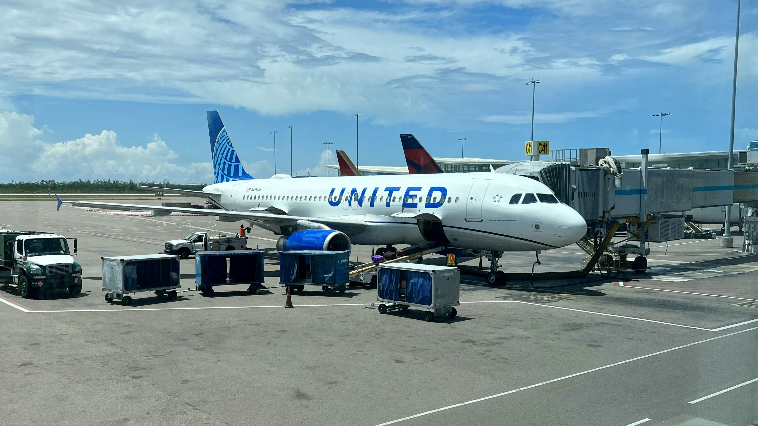 A United Jet sitting on top of an airport tarmac ready for passenger and luggage loading