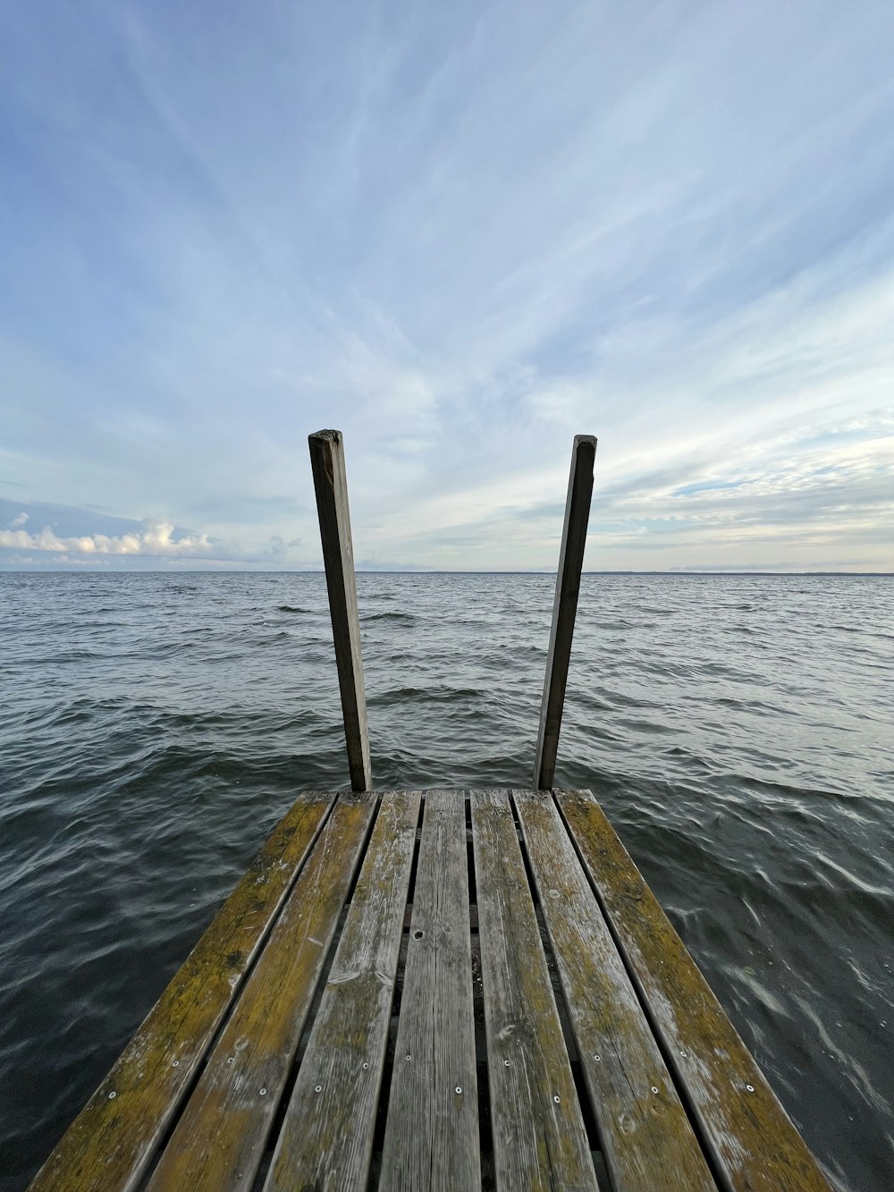 a wooden dock extending out into the ocean