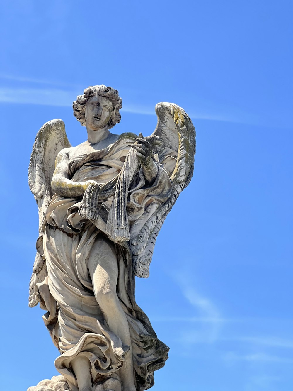 a statue of an angel holding a cross