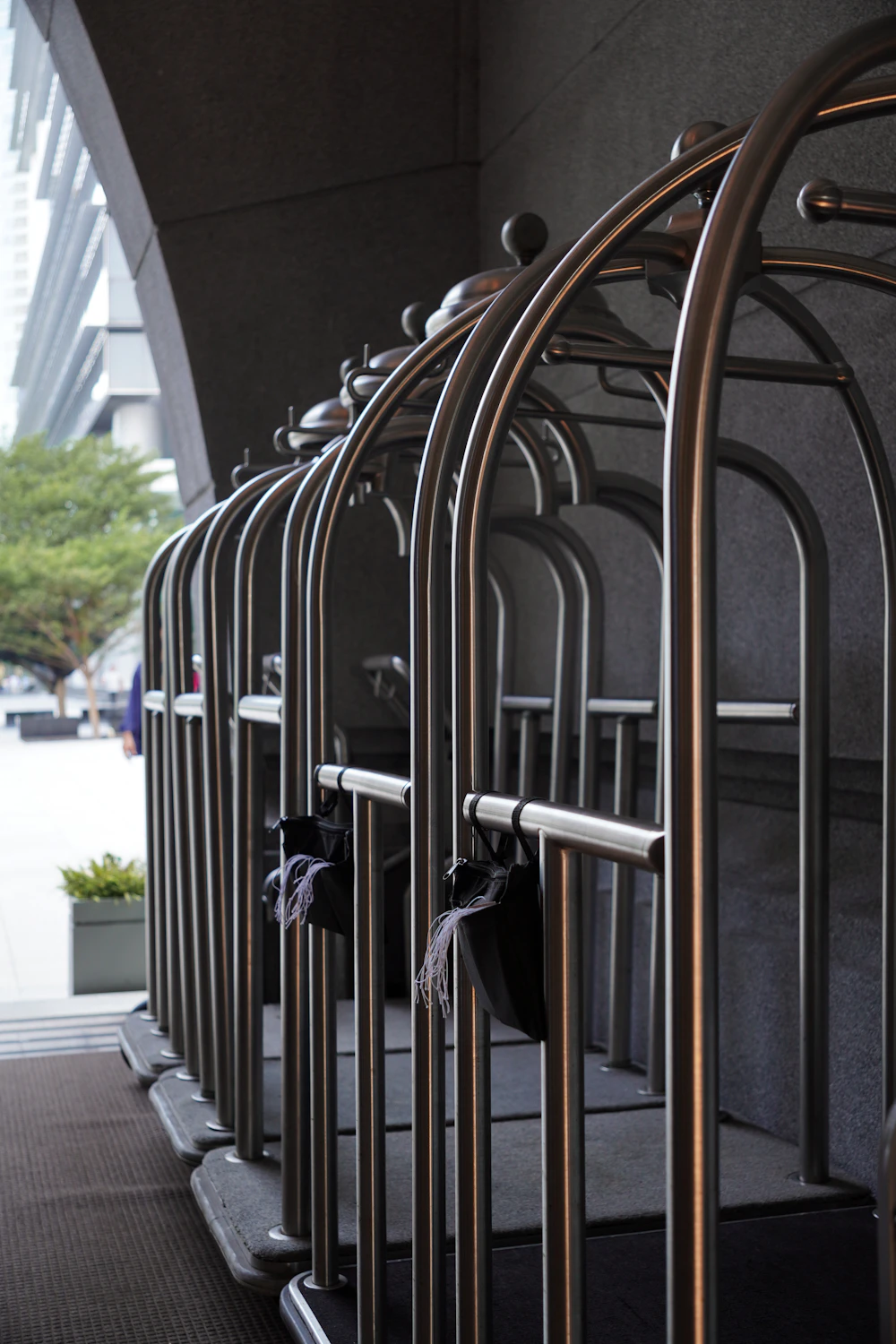 A row of brass hotel luggage carts