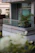 Elegant modern balcony with sleek glass enclosures reflecting a sunset.