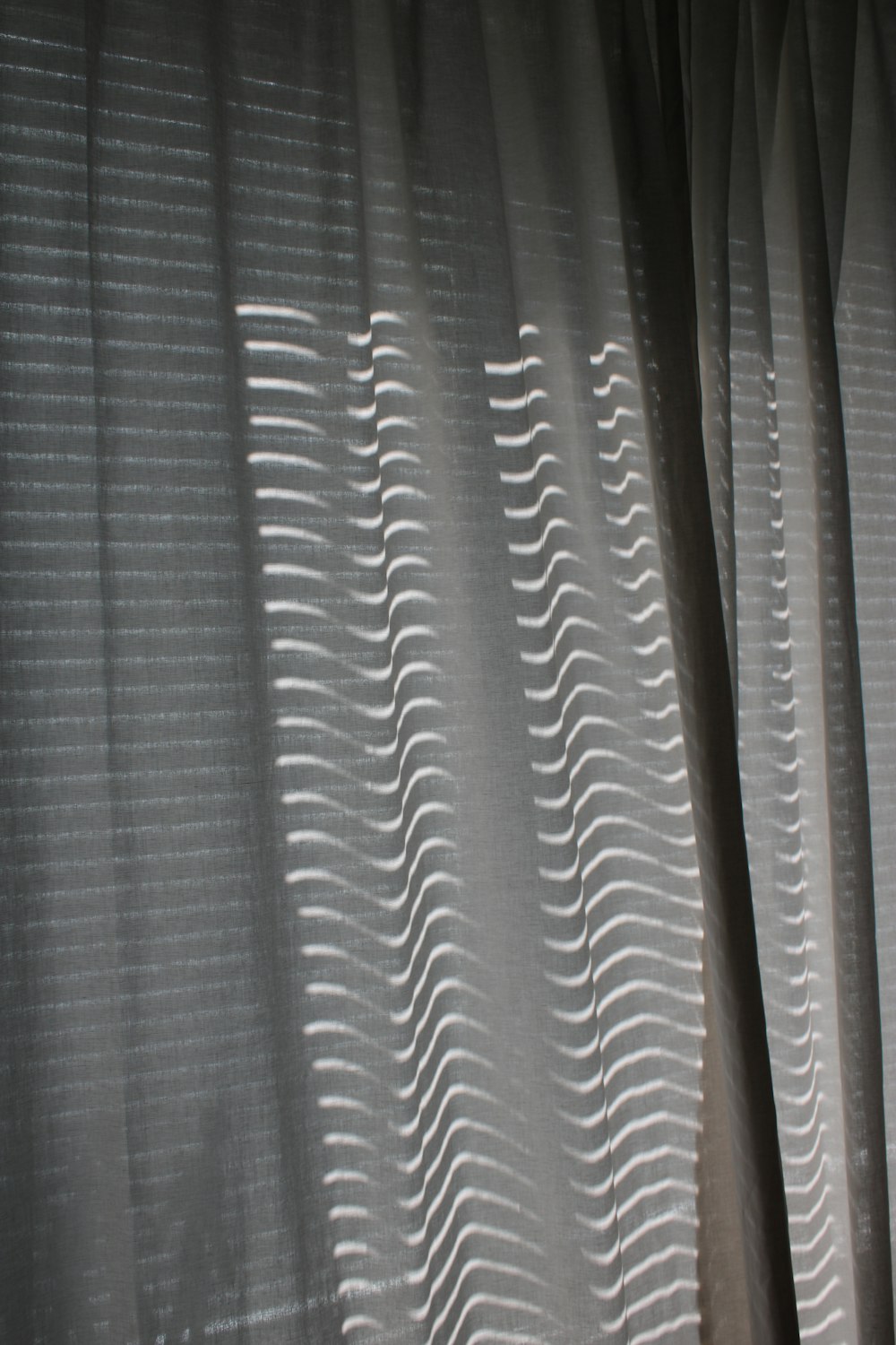 a close up of a curtain with wavy lines