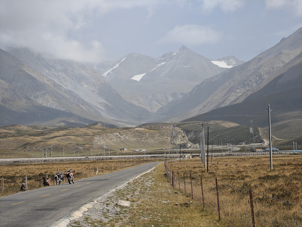 a group of people standing on the side of a road