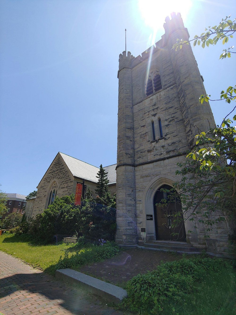 an old stone church with a steeple on a sunny day