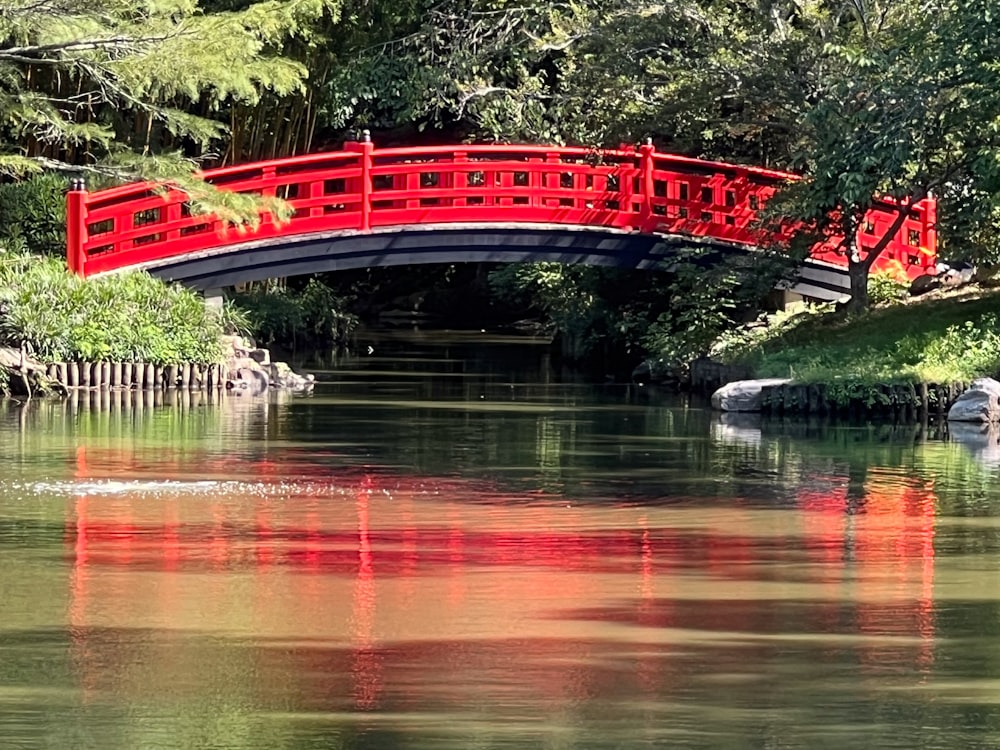 a red bridge over a body of water