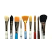 Colorful sponges and brushes arranged on a clean white background.