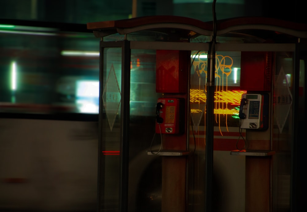a public phone booth on a city street at night