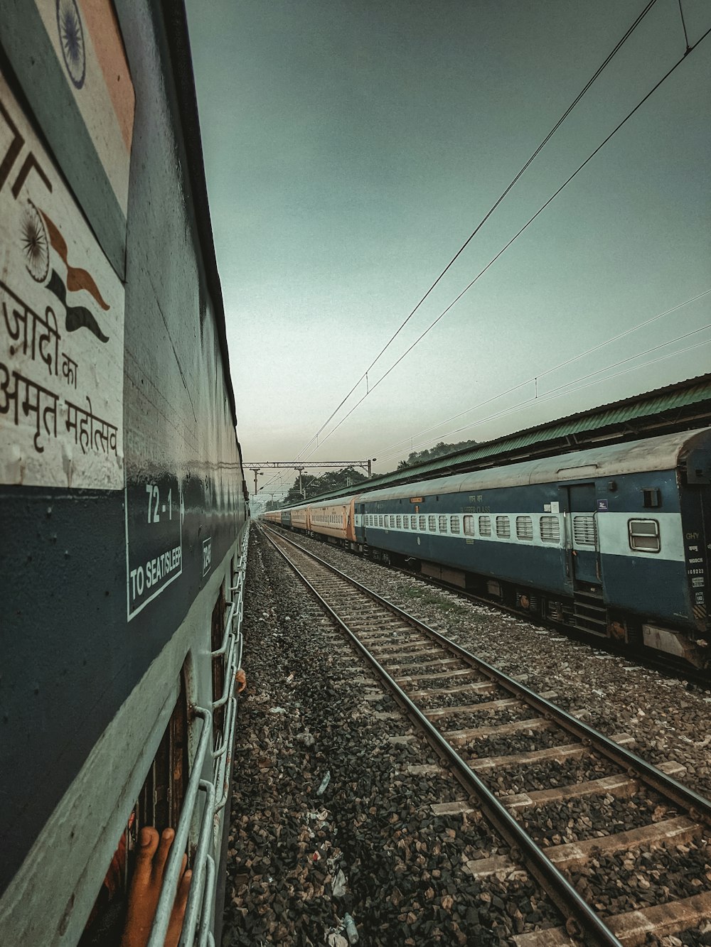 a train traveling down train tracks next to another train