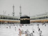a group of people standing around a large building