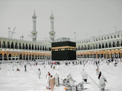 a group of people standing around a large building