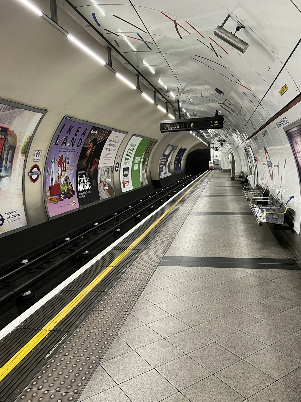 a subway station with a train pulling into the station