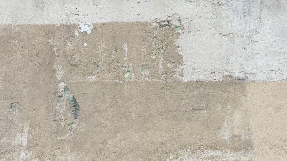 a red fire hydrant sitting on the side of a cement wall