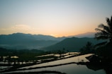 Scenic view of lush green hills and rice fields in Kabupaten Buol at sunrise