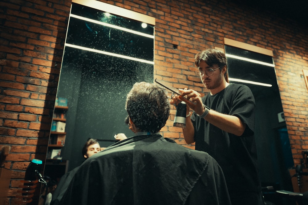 a man getting his hair cut in front of a mirror