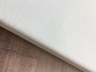 Close-up of a high-quality stretched canvas showing fine texture and craftsmanship.