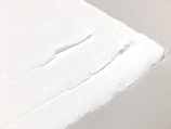 Close-up of paper edges showing quality and thickness under soft lighting.