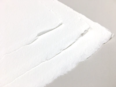 Close-up of paper edges showing quality and thickness under soft lighting.
