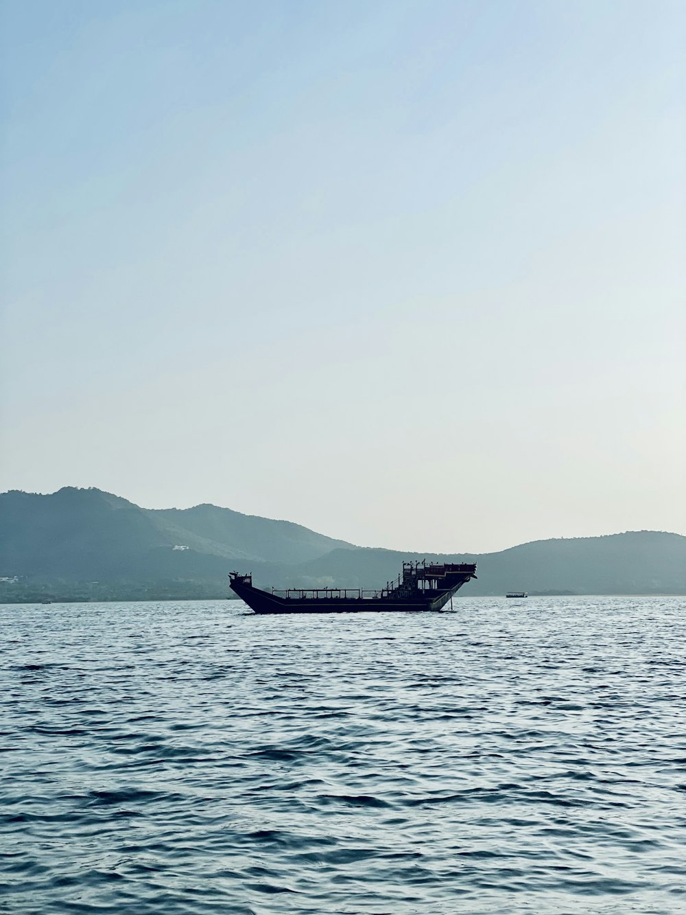 a large boat floating on top of a large body of water