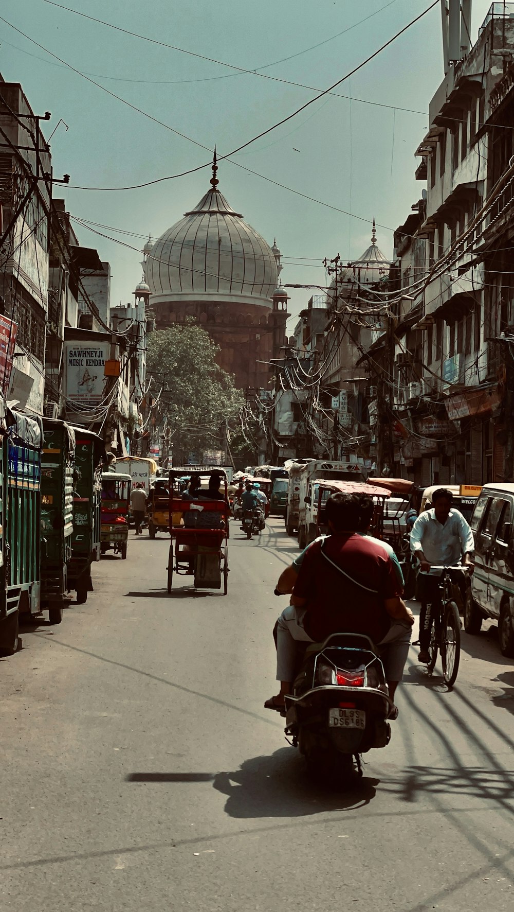 a man riding a motorcycle down a city street