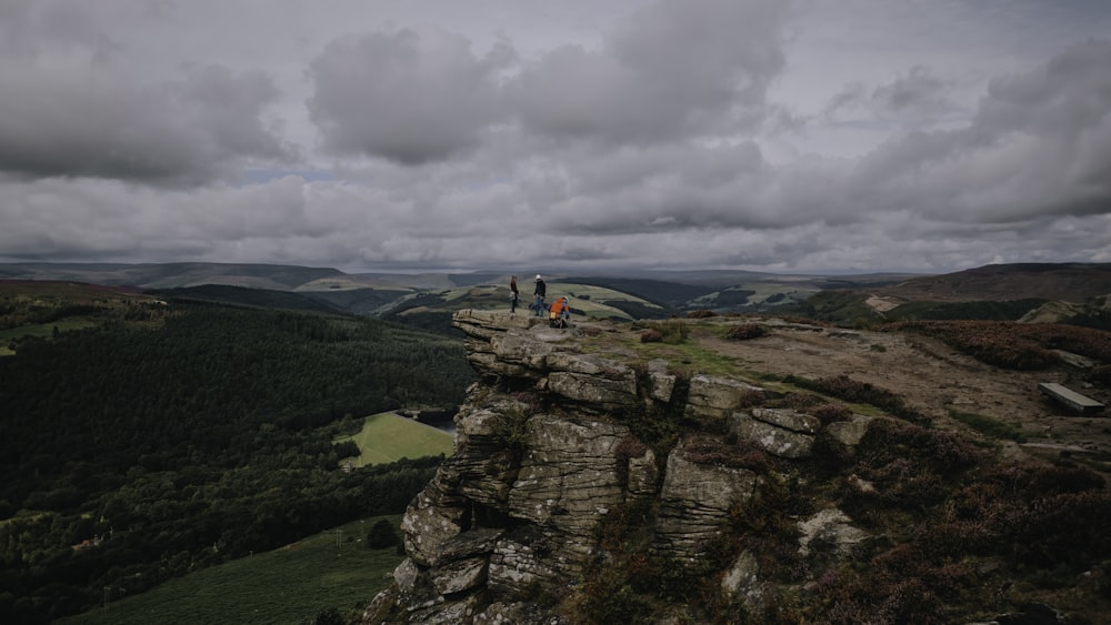 a couple of people standing on top of a mountain