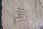 A textured concrete wall features a piece of graffiti with stencil-style text in both English and another language. The poem expresses introspection and connection, with a focus on finding oneself in another's eyes.