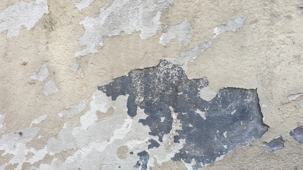 a close up of a wall with peeling paint