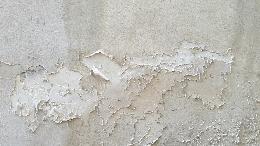 a wall that has some white paint on it