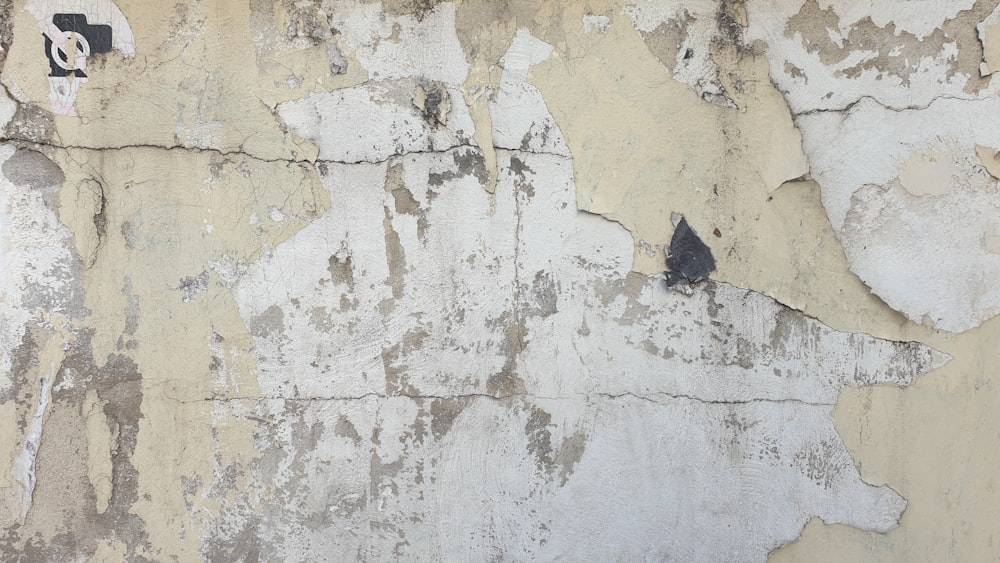 a close up of a wall with peeling paint