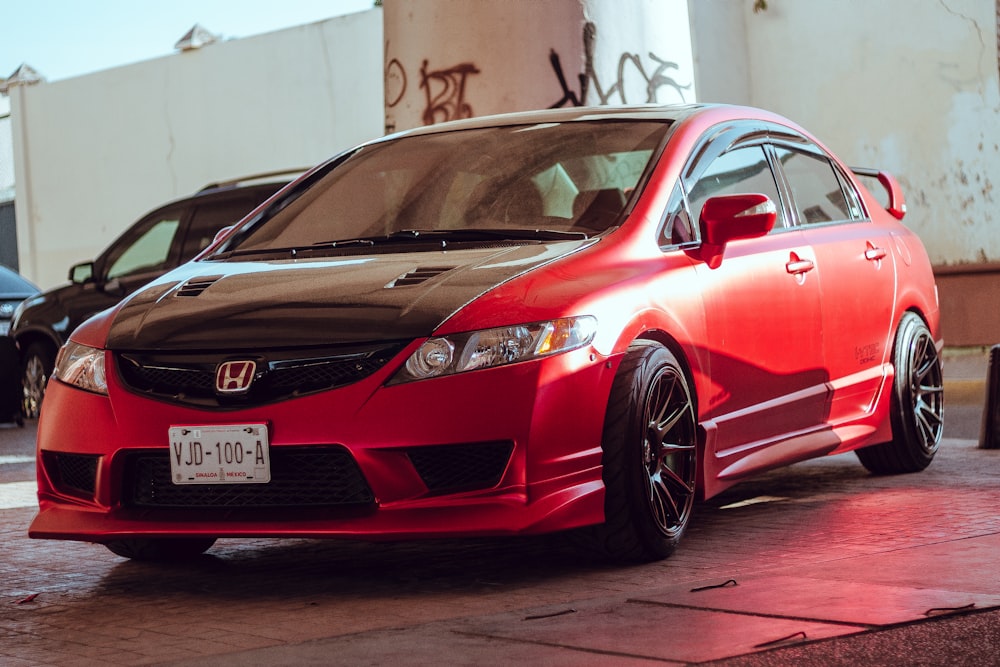 a red car parked in front of a building