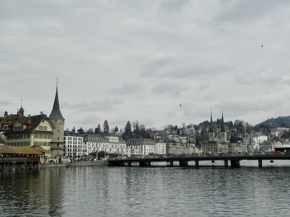 a bridge over a body of water with buildings in the background