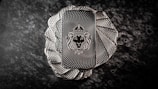 A stack of intricately designed rectangular silver bars with a lion's head wearing a crown engraved in the center. The bars have a textured pattern resembling a spiral, creating an elegant and regal appearance. The background is a dark, marbled surface that enhances the metallic shine of the bars.