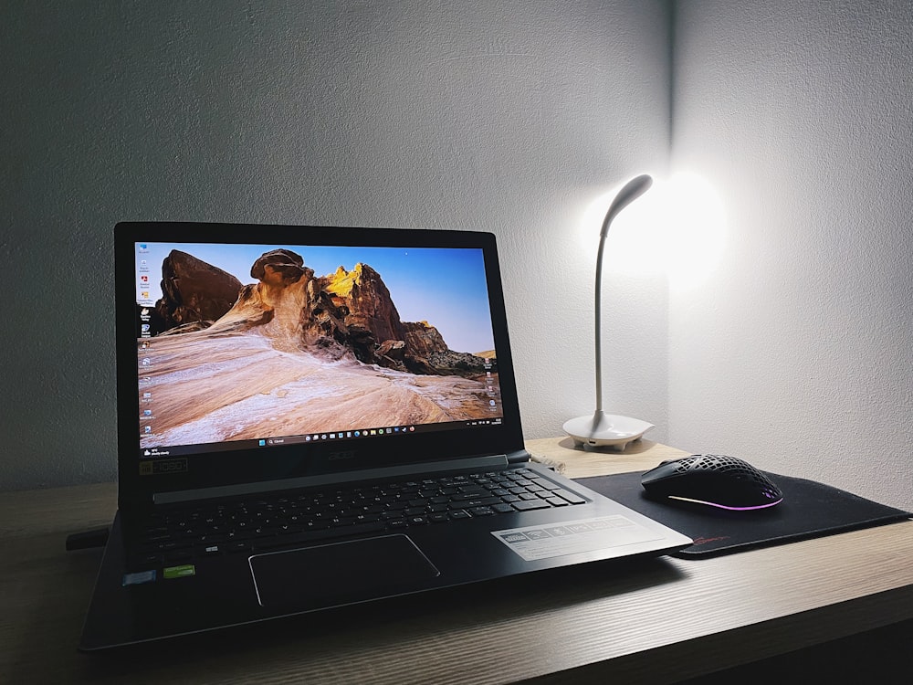 a laptop computer sitting on top of a wooden desk