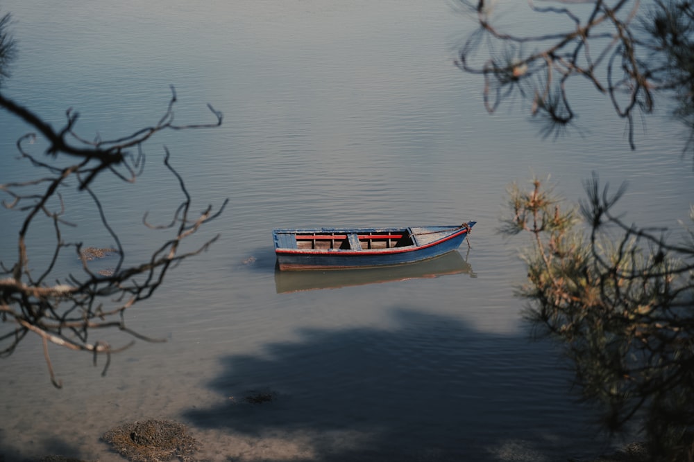 a small boat floating on top of a lake