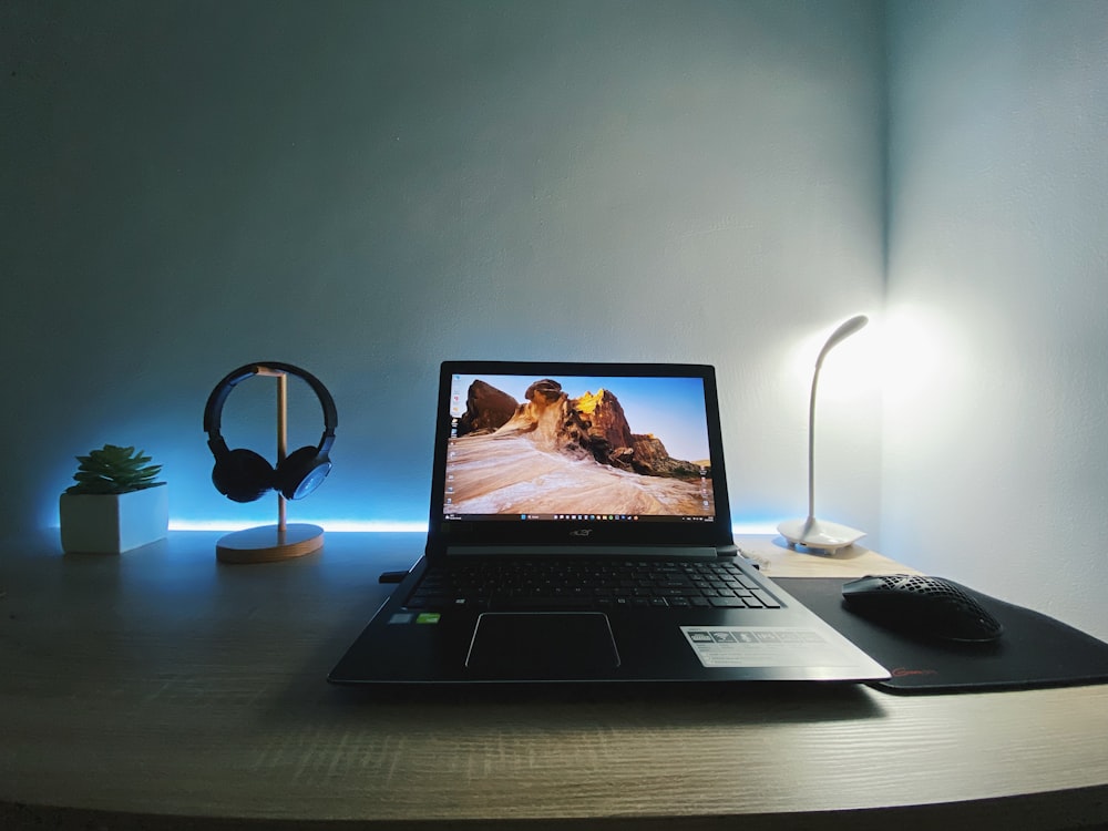 a laptop computer sitting on top of a wooden desk