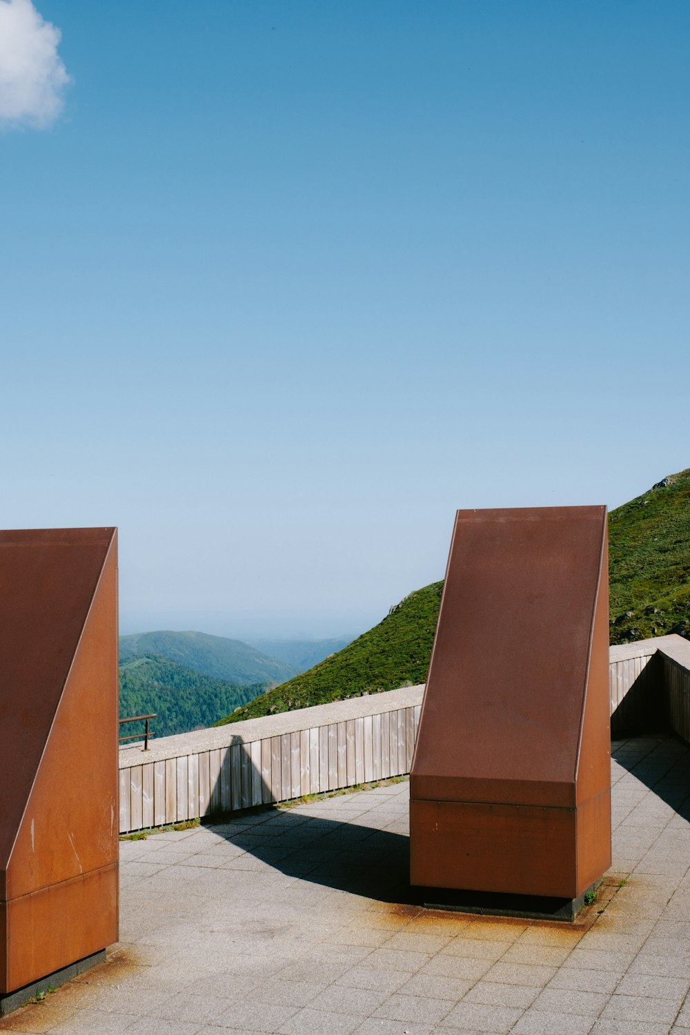 a couple of metal structures sitting on top of a cement field