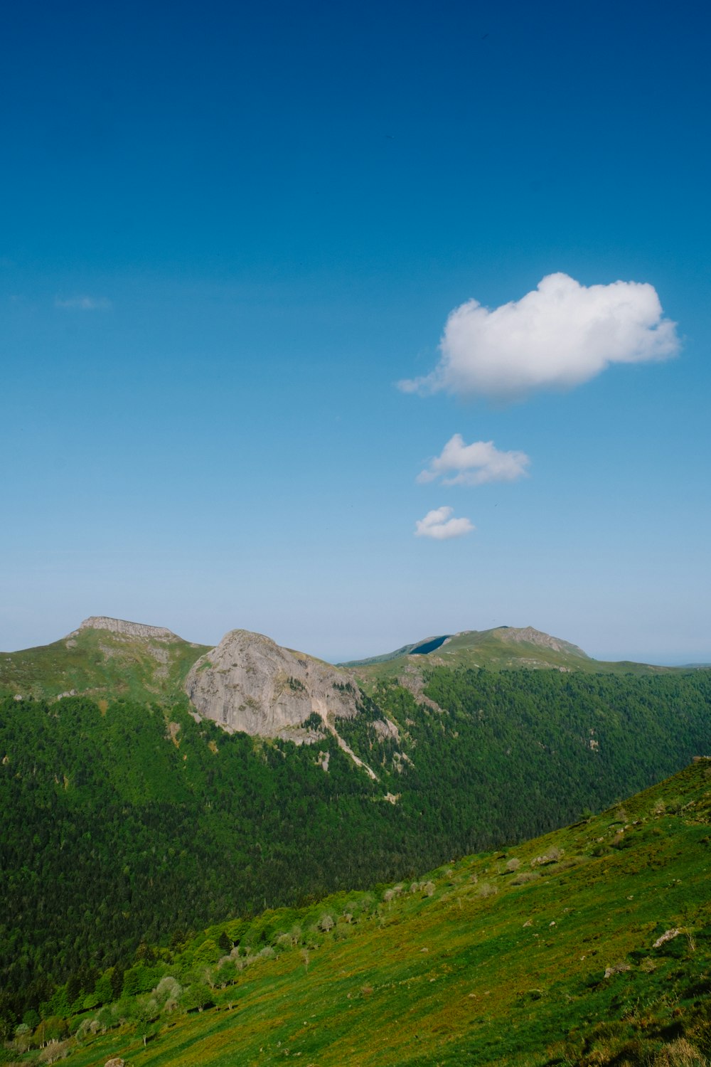 a view of a mountain range with a cloud in the sky