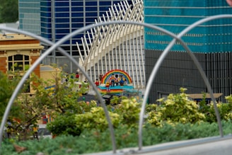 A colorful street scene model built from building blocks, showing tiny cars and shops.