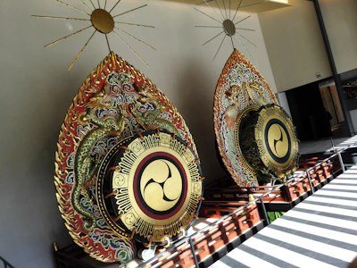 Traditional kendang drums with vibrant painted details, set against a backdrop of bamboo.